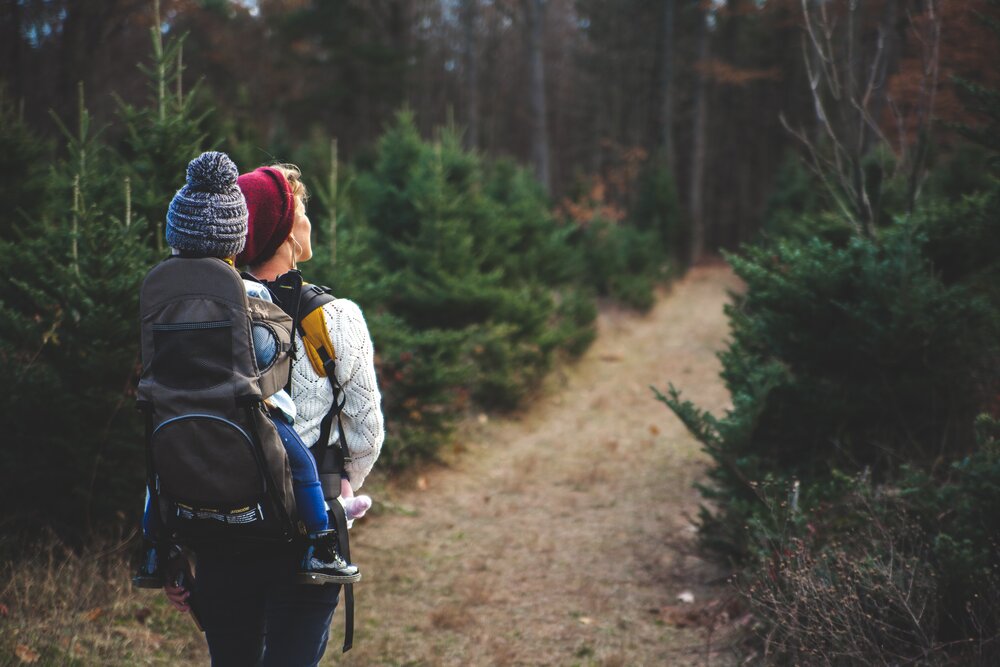 woman hiking with infant son on back, pelvic girdle pubic pain