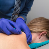 How does adding dry needling to Physical Therapy interventions help patients with shoulder pain?
